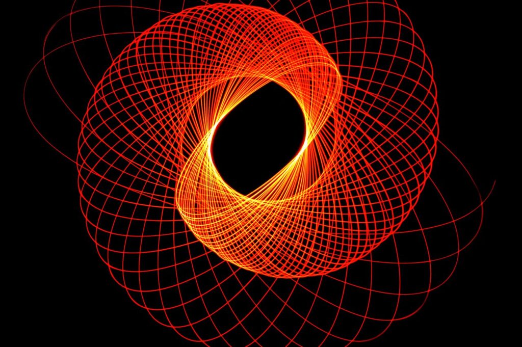 Dynamic abstract neon light pattern forming a geometric circular spiral on a black background.