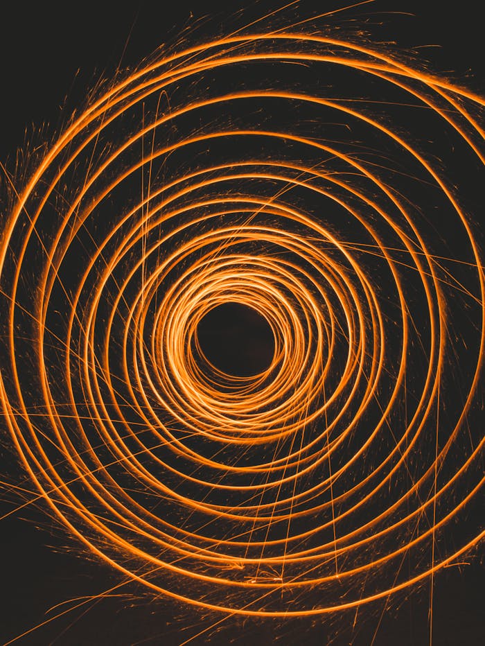 Dynamic spiral light trails captured in a long exposure for a mesmerizing effect.